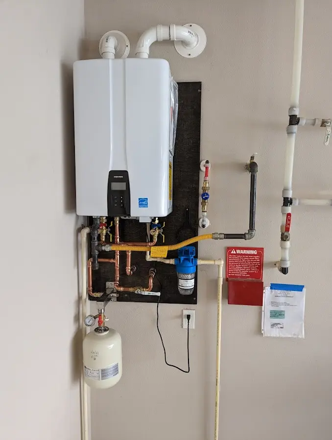 Professional plumber installing copper piping in a Kirkland home